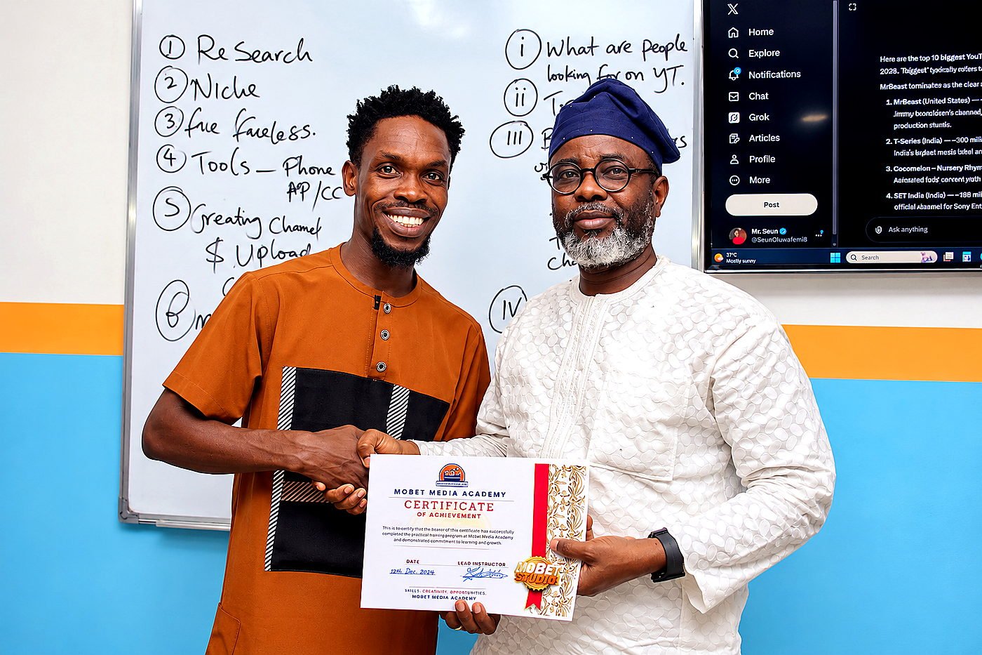 Mr. Mobet presenting a certificate to a participant during a practical training programme